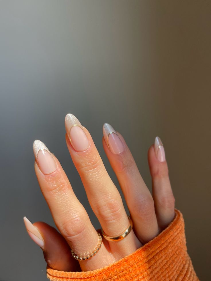 Sophisticated Almond-Shaped Nails with Nude and Glitter Tips Creations.