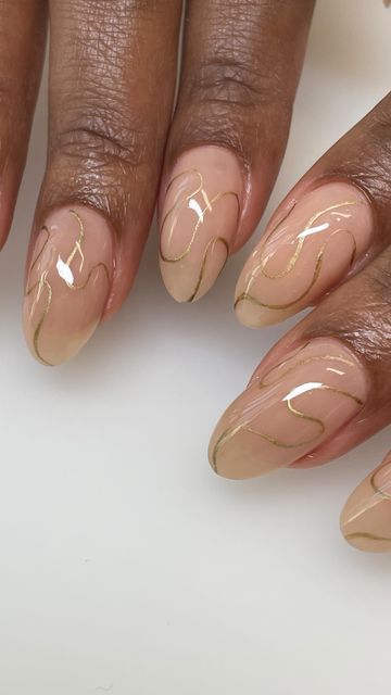 Elegant Nude Nail Design with Delicate Gold Accents for a Modern Aesthetic.