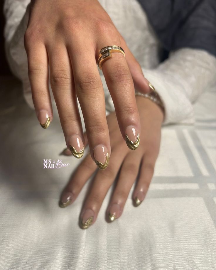 Chic Nude Nail Design with Gold French Tips for Elegant Occasions.