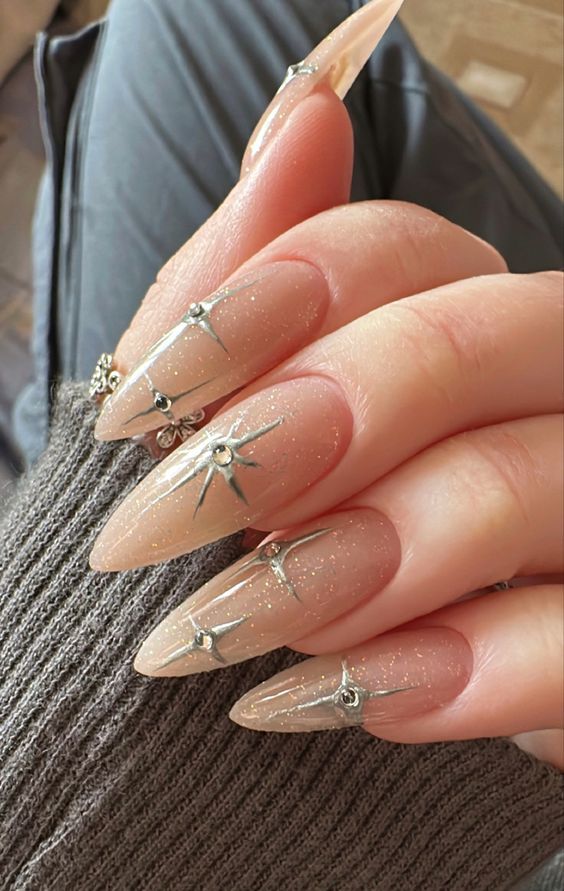 Chic Almond-Shaped Nude Nails with Glamorous Sparkling Accents.