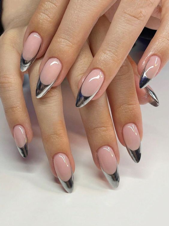 Chic Soft Pink Nail Design with Striking Black Tips and Elongated Shape