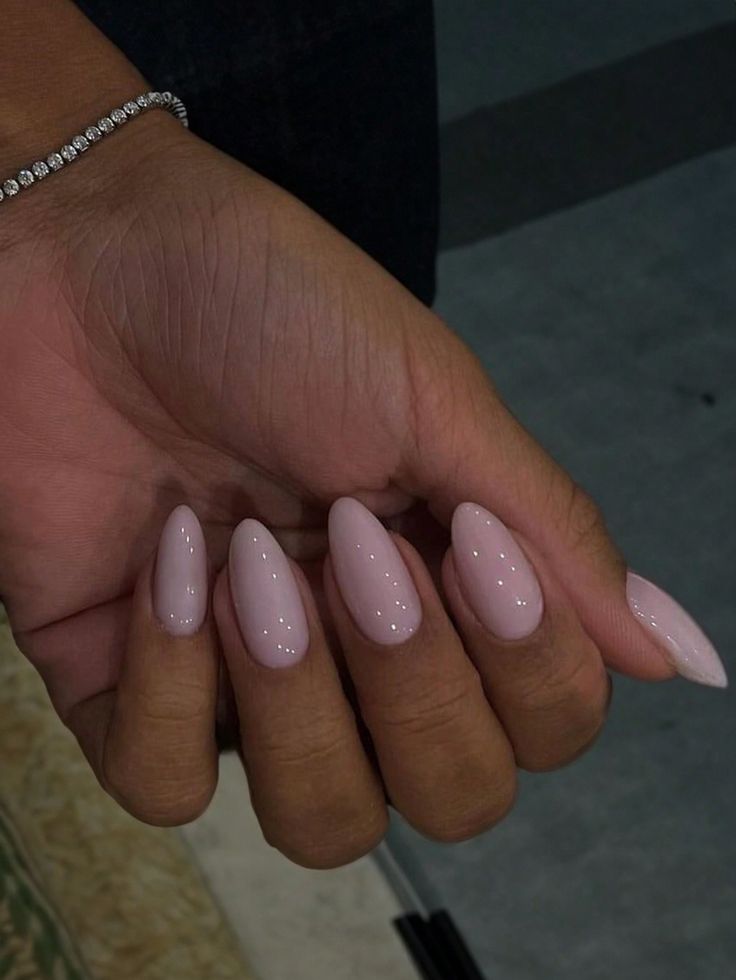 Sophisticated Almond-Shaped Nails with Glossy Pink Polish: A Timeless Chic Look.