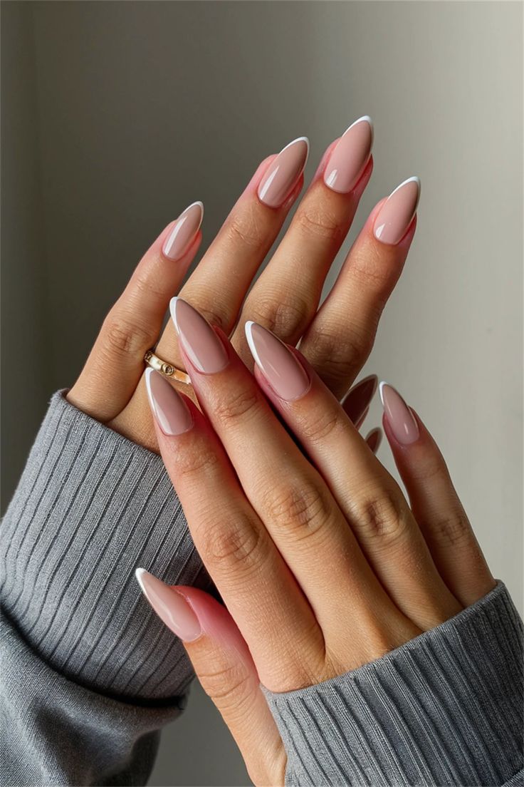 Sophisticated French Manicure with Almond-Shaped Nails Paired with a Chic Grey Sweater.