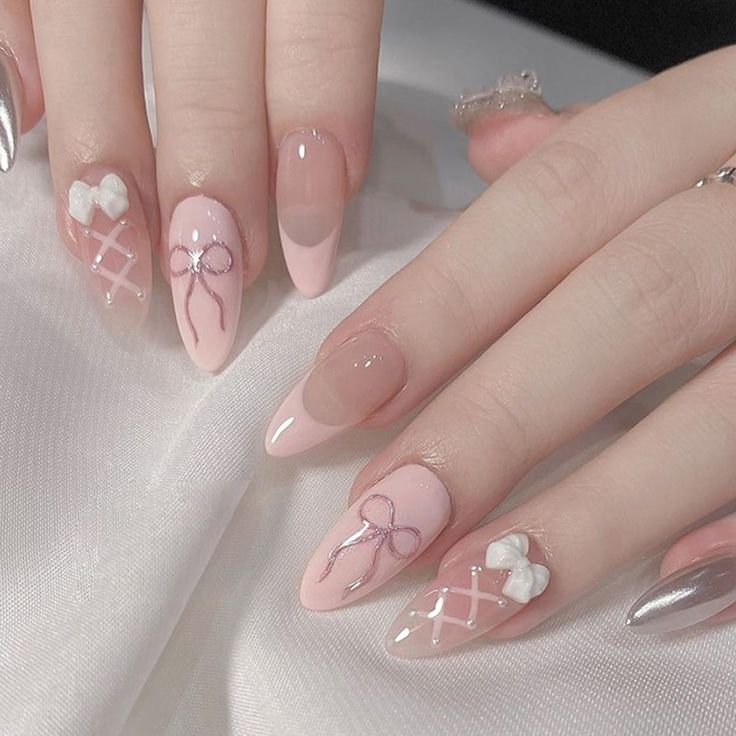 Charming Soft Pink Nail Design with Artistic Accents and Contemporary Finishes.