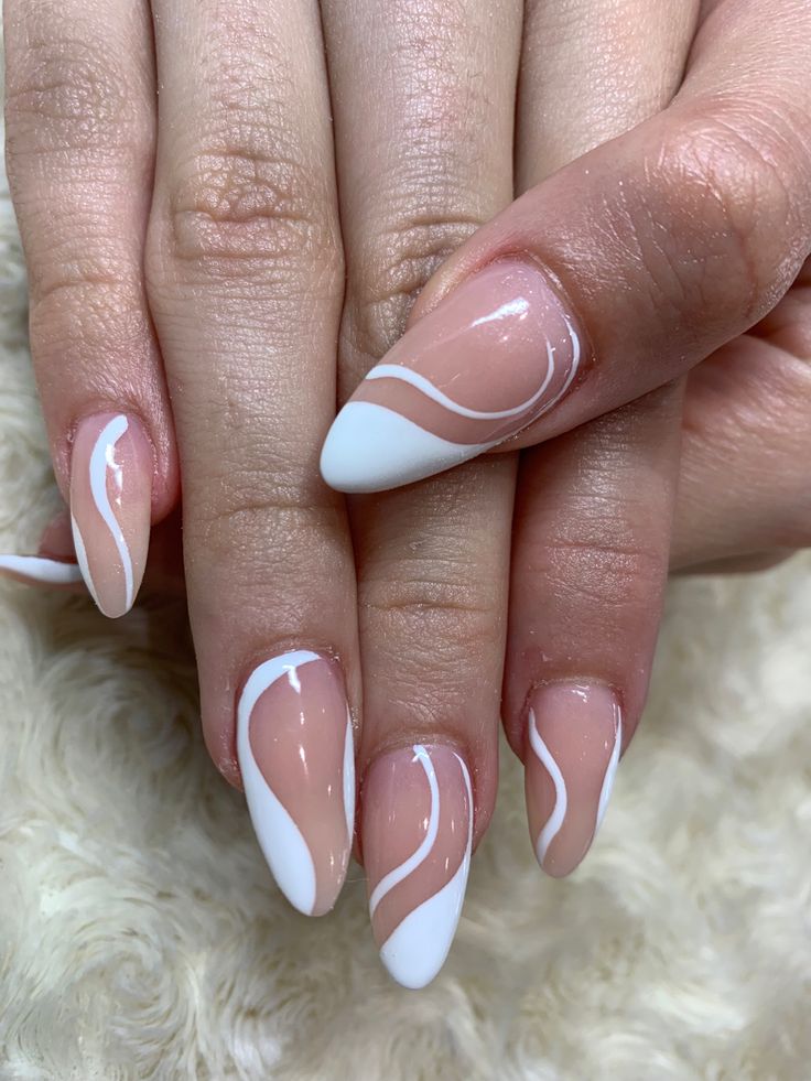 Chic Almond-Shaped Nails: A Modern Blend of Soft Nude and Crisp White with Fluid Wavy Patterns.