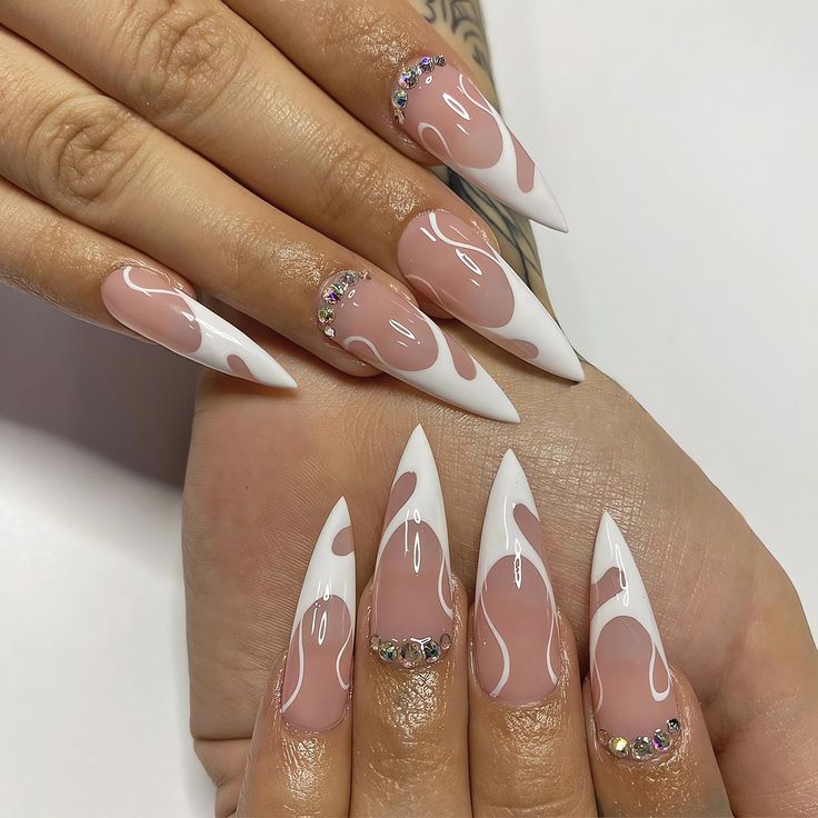 Chic Stiletto Nails: Soft Pink Base with White Tips and Rhinestone Accents.