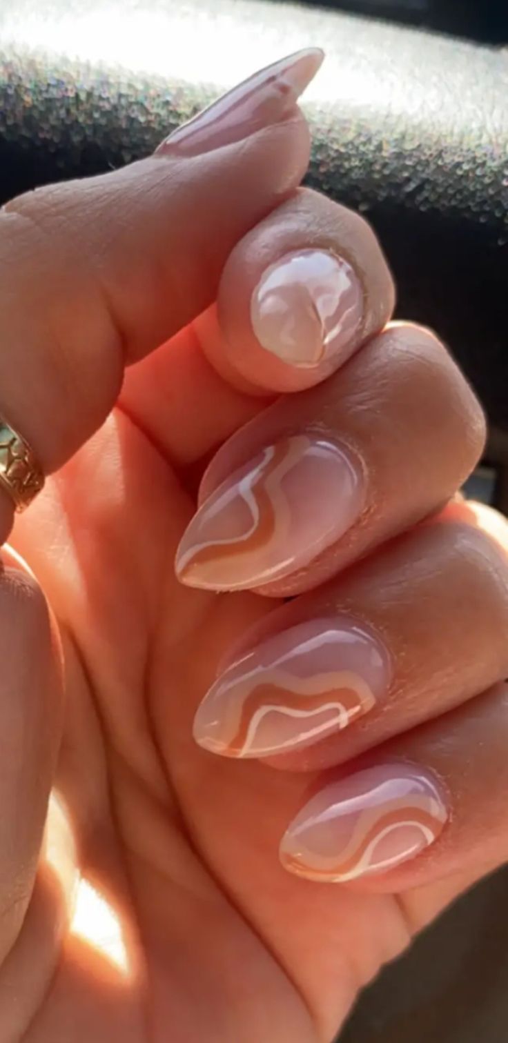 Sophisticated Almond-Shaped Nail Design with Soft Nude Base and Creamy White-Peach Accents