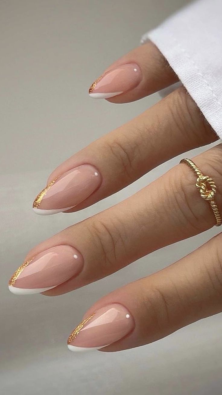 Sophisticated Nude Nail Design with Gold Tips and Elegant Embellishments.