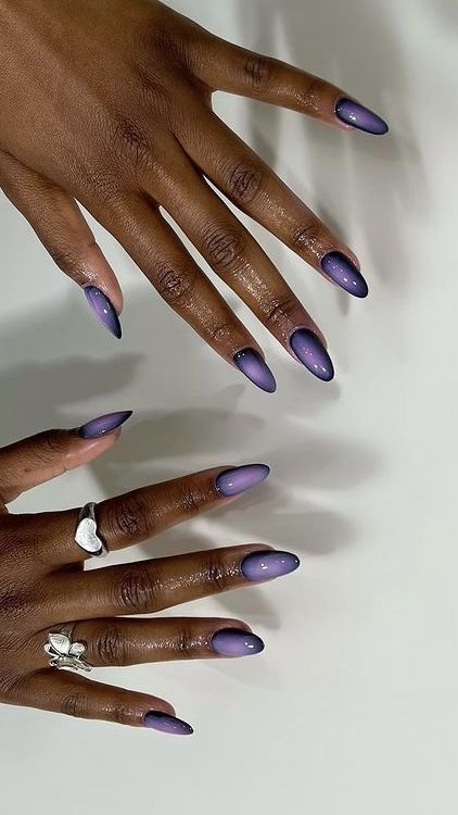 Elegant Gradient Oval Nail Design: Deep Purple to Soft Lavender with Glossy Finish and Silver Accents.