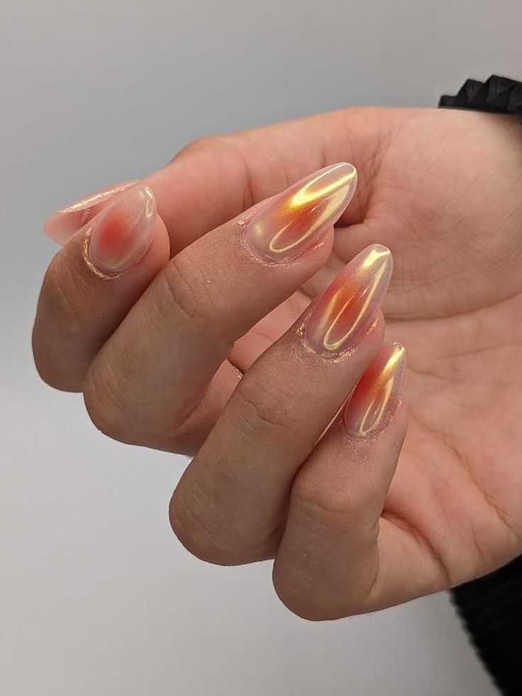 Radiant Almond-Shaped Nail Design with Gradient Peach to Golden Effect.