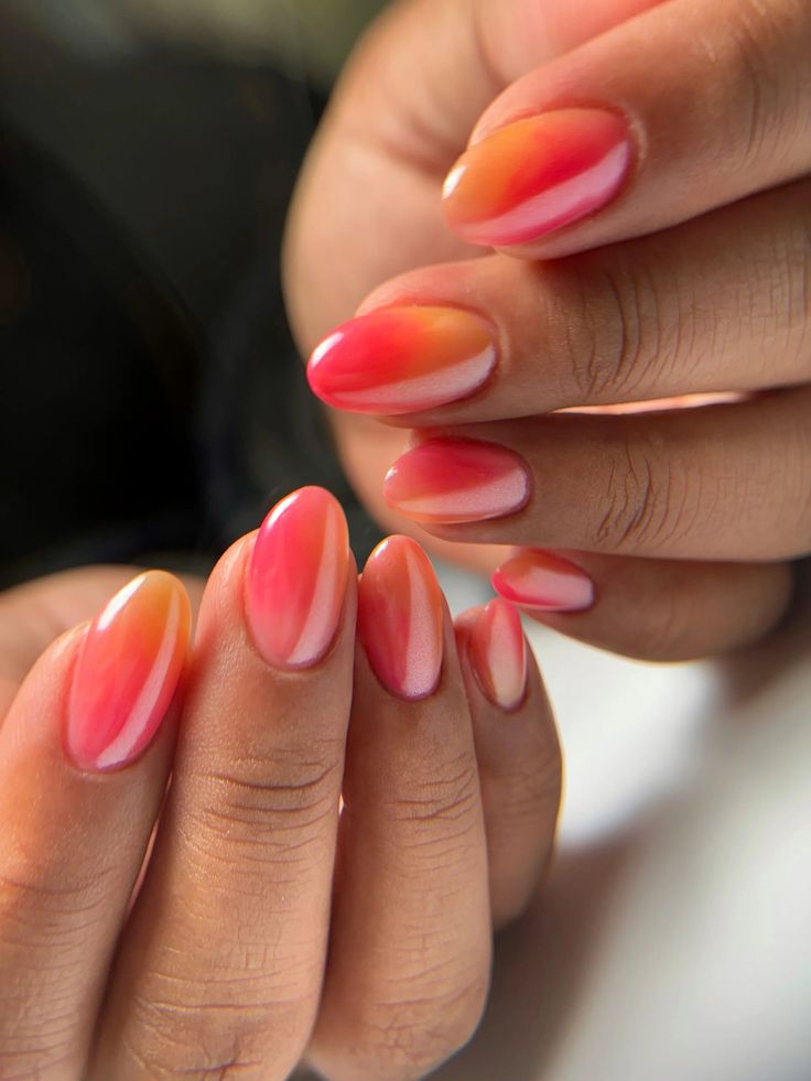 Vibrant Orange and Pink Gradient Nail Design: A Playful, Elegant Touch for Any Occasion.