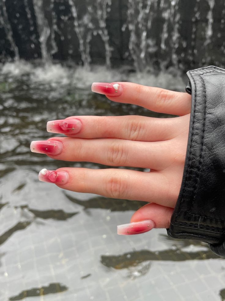 Striking Ombre Nail Design with Glossy White Tips and Intricate Marble Patterns.