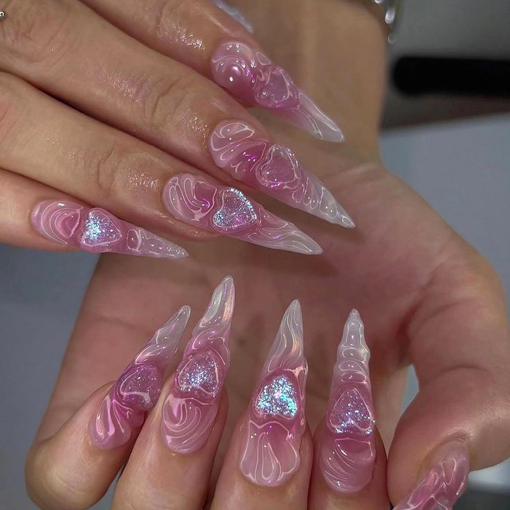 Sophisticated Stiletto Nails Featuring Swirled Pink Design with Glitter and Heart Accents.