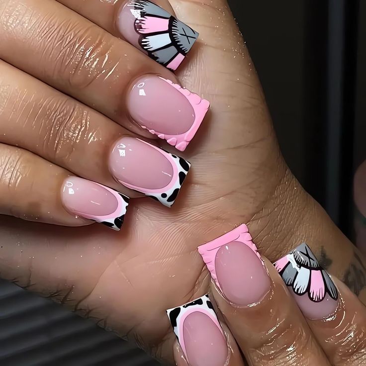 Chic Pink and Black Nail Design with Playful Patterns and Textured Accents.