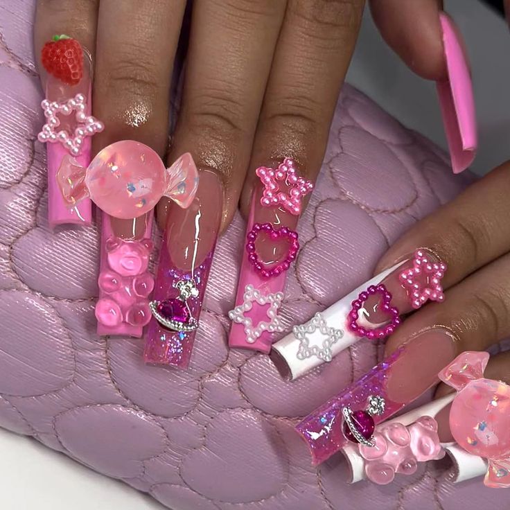 Whimsical Vibrant Pink Nail Design with 3D Candy, Stars, and Floral Accents.