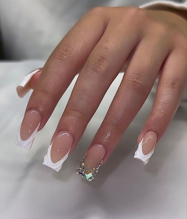 Chic Almond-Shaped Nude Nail Design with Rhinestone Accents for Elegant Versatility.