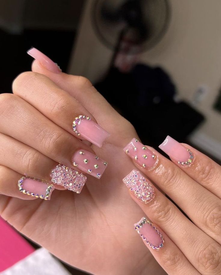 Elegant Soft Pink Acrylic Nail Design with Sparkling Rhinestones for a Chic Look.