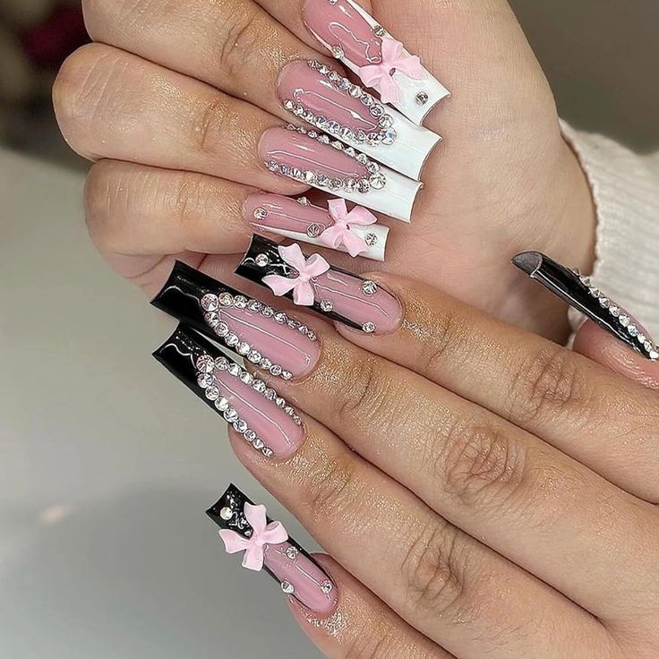 Elegant Nail Design: Glossy Pink with Black and White Tips, Enhanced by Bows and Rhinestones