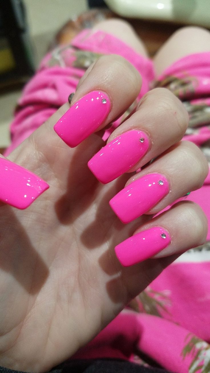 Bold Glossy Pink Nails with Glamorous Rhinestones.