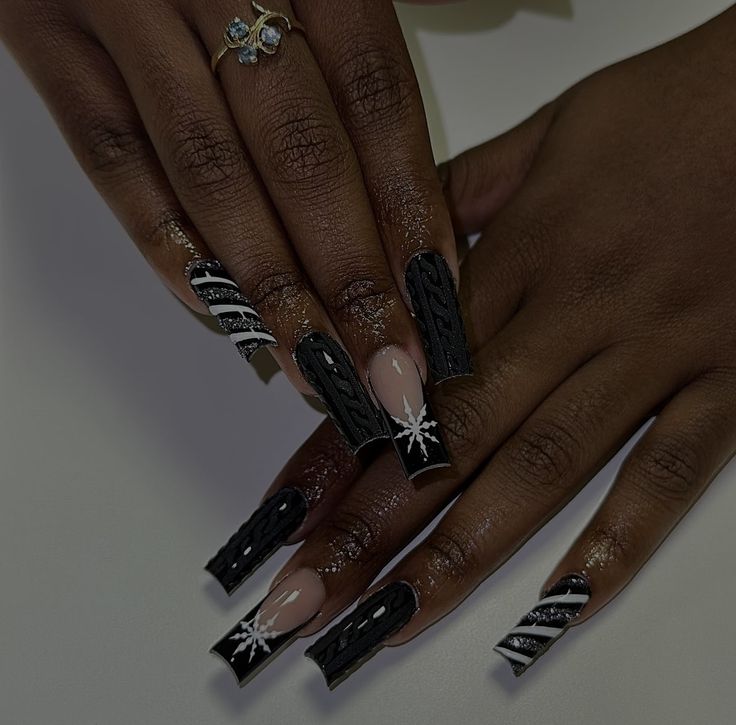 Chic Winter Nail Design: Dramatic Black Tips with Cable-Knit Patterns and Snowflake Accents