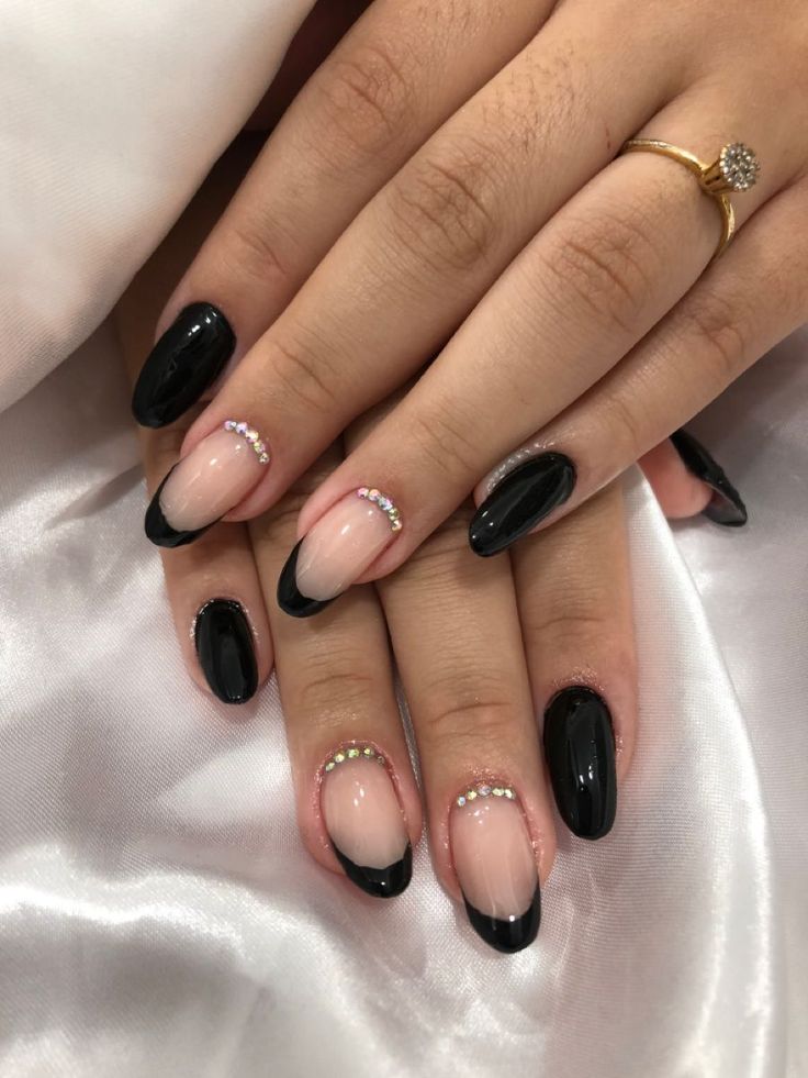 Chic Black and Nude Nail Design with Glamorous Rhinestones for Any Occasion.