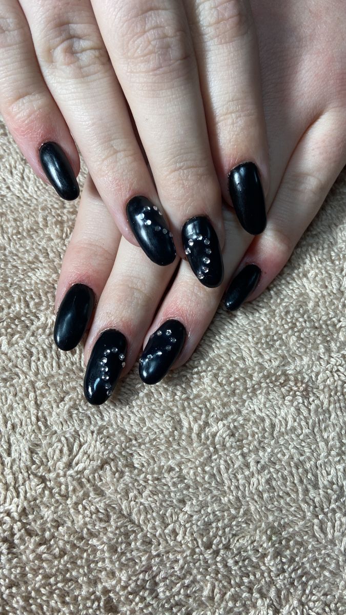 Chic Black Nail Design with Glossy Finish and Rhinestone Accents for All Occasions.