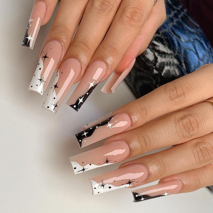 Chic Nail Design: Soft Nude Meets Striking Black and White with Starry French Tips.