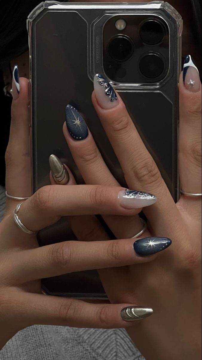 Sophisticated Deep Blue and White Nail Design with Silver Accents and Gem Embellishments.