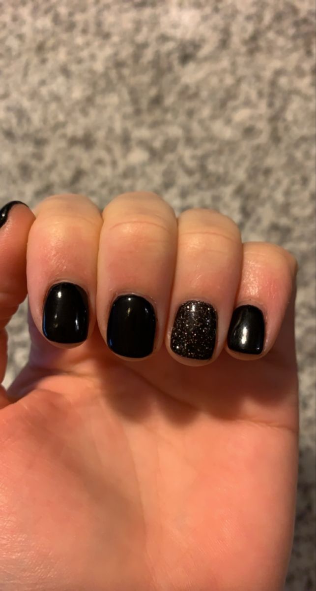 Elegant Black Nail Design with Glossy Finish and Sparkling Accent for Glamorous Sophistication.