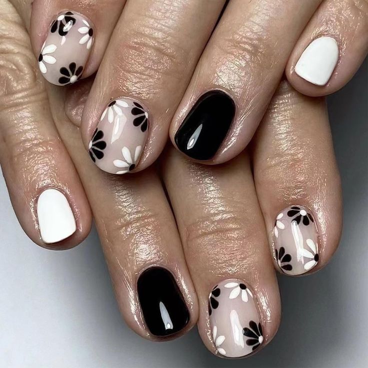 Elegant Floral Nail Design in Black, White, and Nude Shades