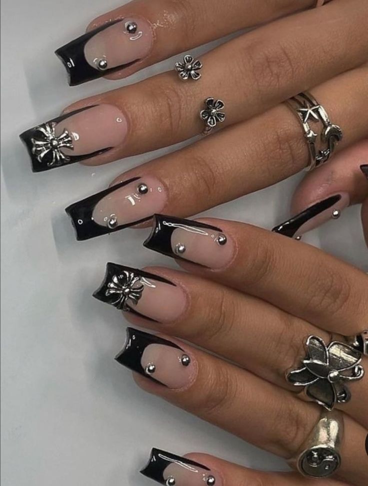 Modern Black and Nude Nail Design with Metallic Beads and Floral Accents