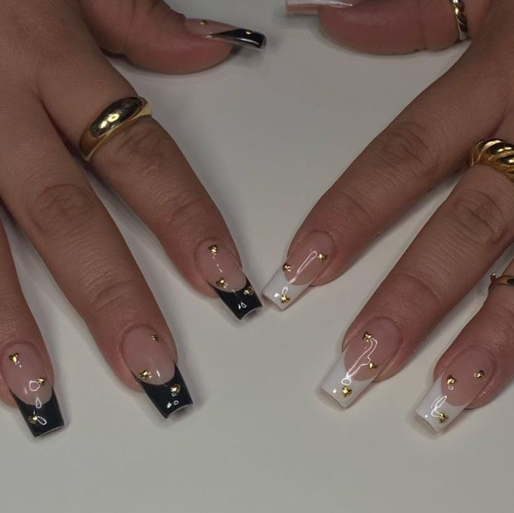 Sophisticated Nail Design: Classic French Tips with Modern Color Accents and Glamorous Embellishments.