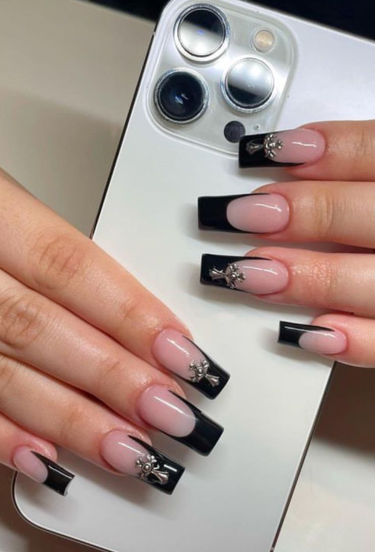 Sophisticated Nude and Black Nail Design with Glossy Tips and Elegant Silver Accents.