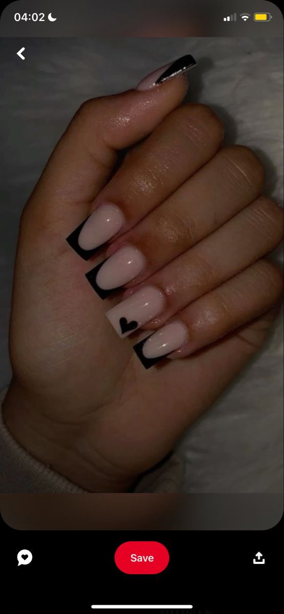 Sophisticated Nail Design: Neutral Base with Bold Black Tips and Playful Heart Detail