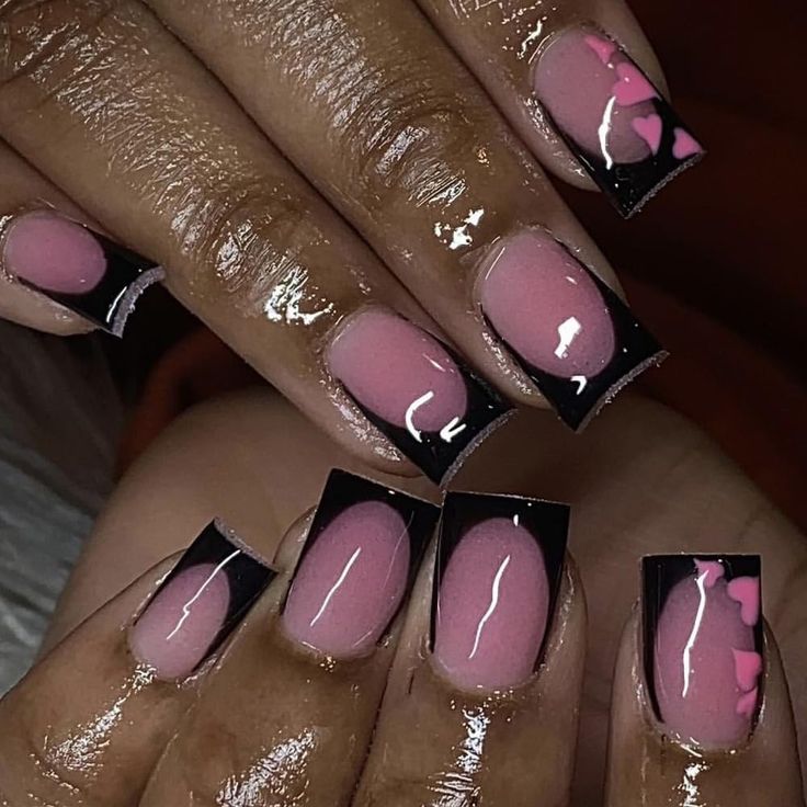 Chic Pink and Black Nail Design with Glossy Tips and Playful Heart Accents.