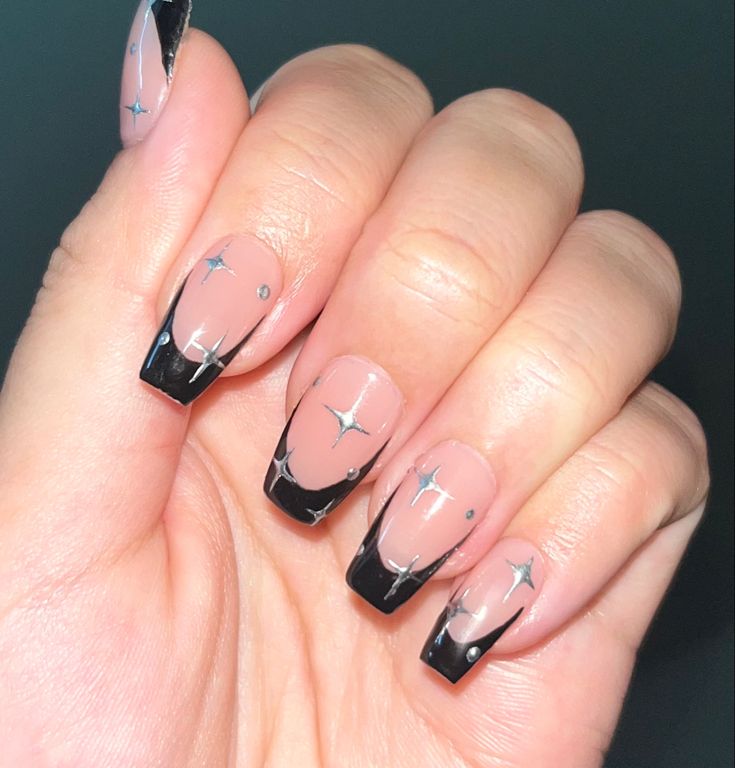 Chic Nude and Black Nail Design with Celestial Silver Accents for Modern Sophistication.