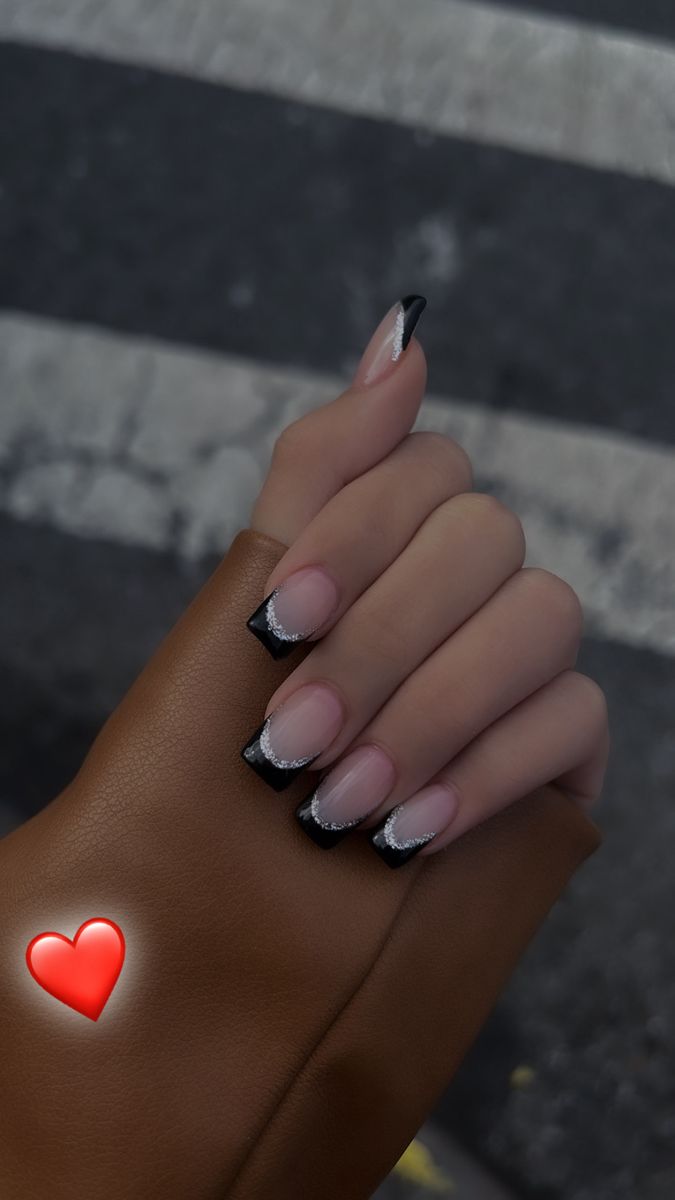 Chic Elegant Nail Design: Natural Nude Base with Striking Black Tips and Delicate Silver Accent.