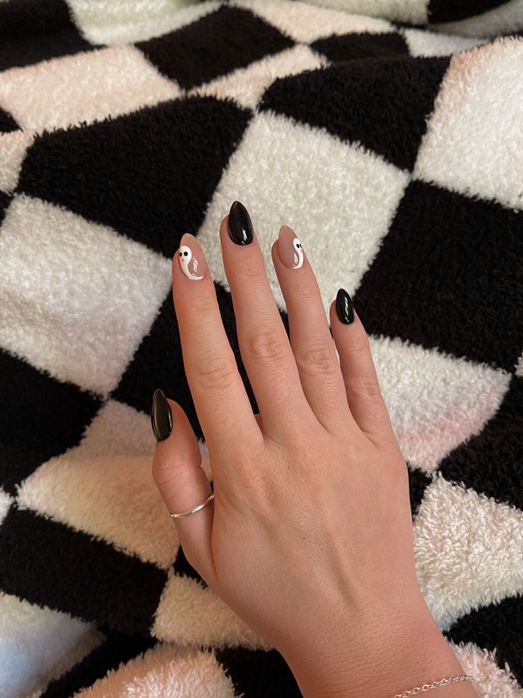 Chic Black and Nude Nail Design with Minimalist Yin and Yang Accents.