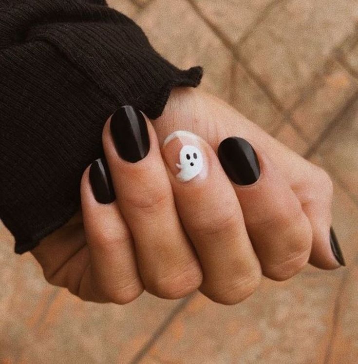 Playful Ghost Motif on Glossy Black Nails: Trendy Halloween Aesthetic.