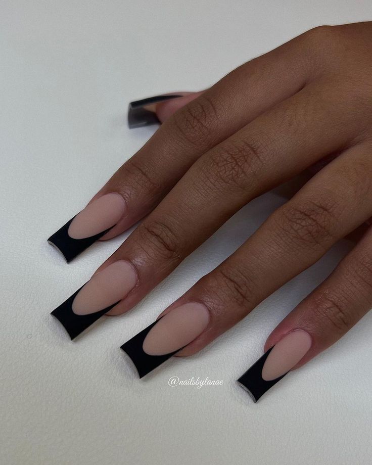 Edgy Nail Design: Bold Black & Nude Colors with Artistic Cut-Outs