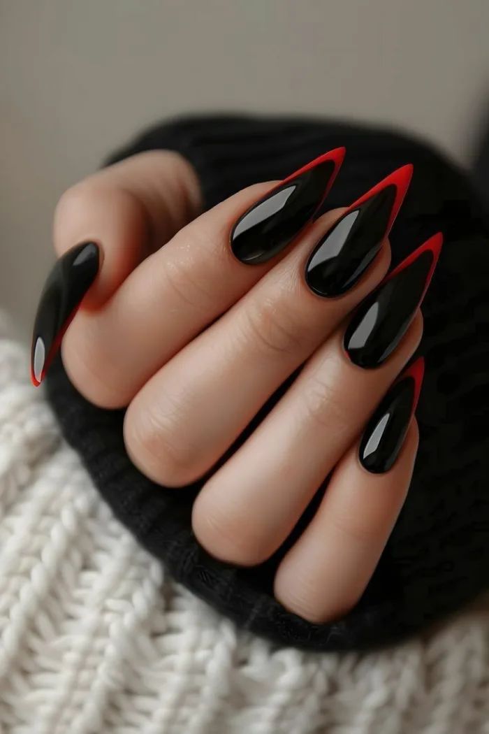 Edgy Almond-Shaped Nail Design: Glossy Black and Vibrant Red Statement Look.