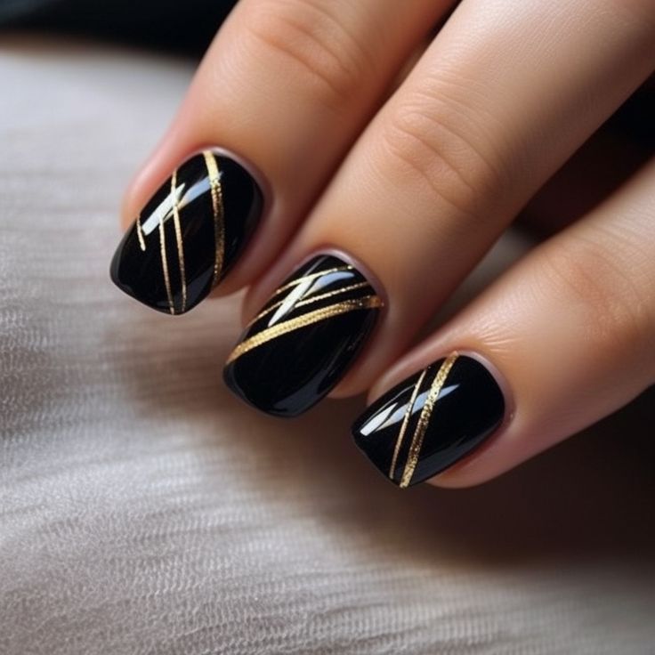 Sleek Chic: Black Nails with Metallic Gold Accents in a Modern Geometric Design.