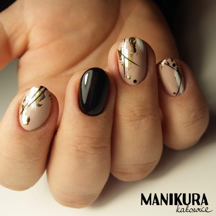 Sophisticated Nude Nail Design with Golden Streaks and Striking Black Accent.