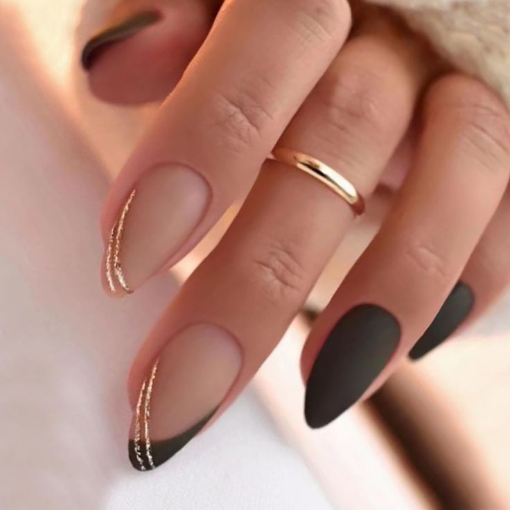 Sophisticated Almond-Shaped Nail Design with Matte Black, Nude, and Gold Accents.