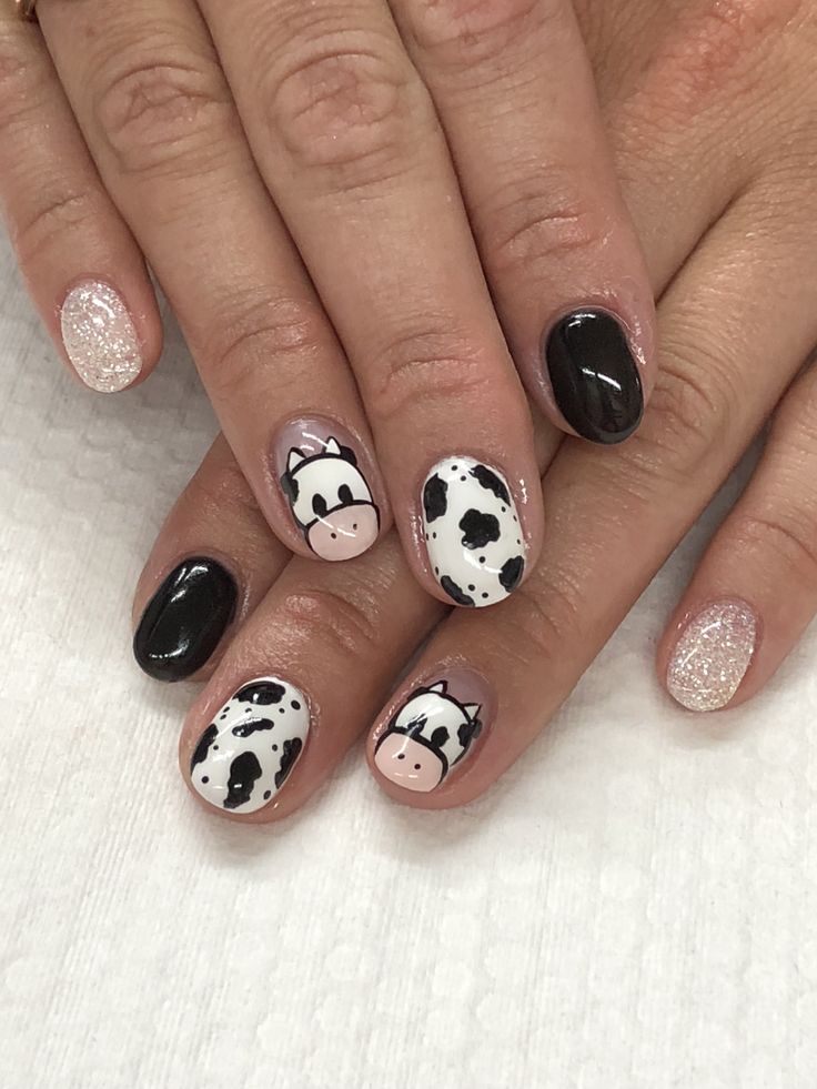 Whimsical Cow-Themed Nail Design with Bold Colors and Glitter Accents.