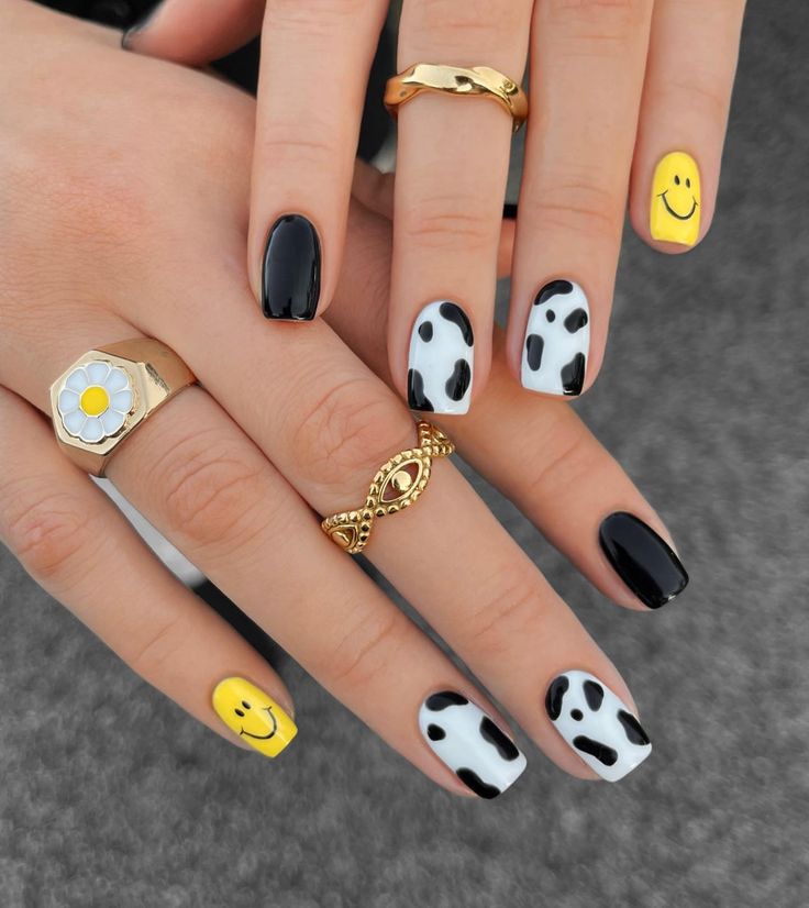 Whimsical Nail Design with Black, White, and Bright Yellow Hues Featuring Glossy Finishes and Fun Patterns.