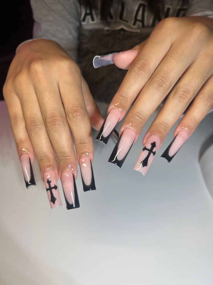 Elegant Nail Design: Soft Pink Meets Bold Black with Striking Cross Accents.