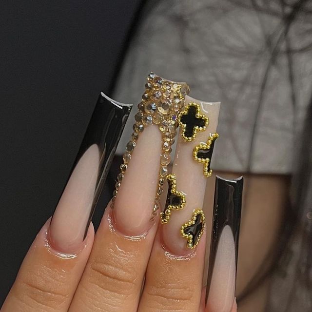 Glamorous Stiletto Nail Design: Black Glossy Ombre with Gold and Rhinestone Accents