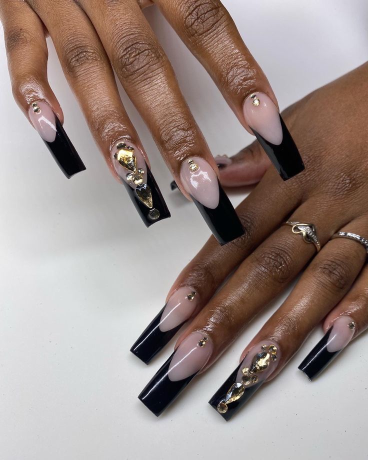 Chic Nude and Black Nail Design with Glamorous Gold Accents and Rhinestones