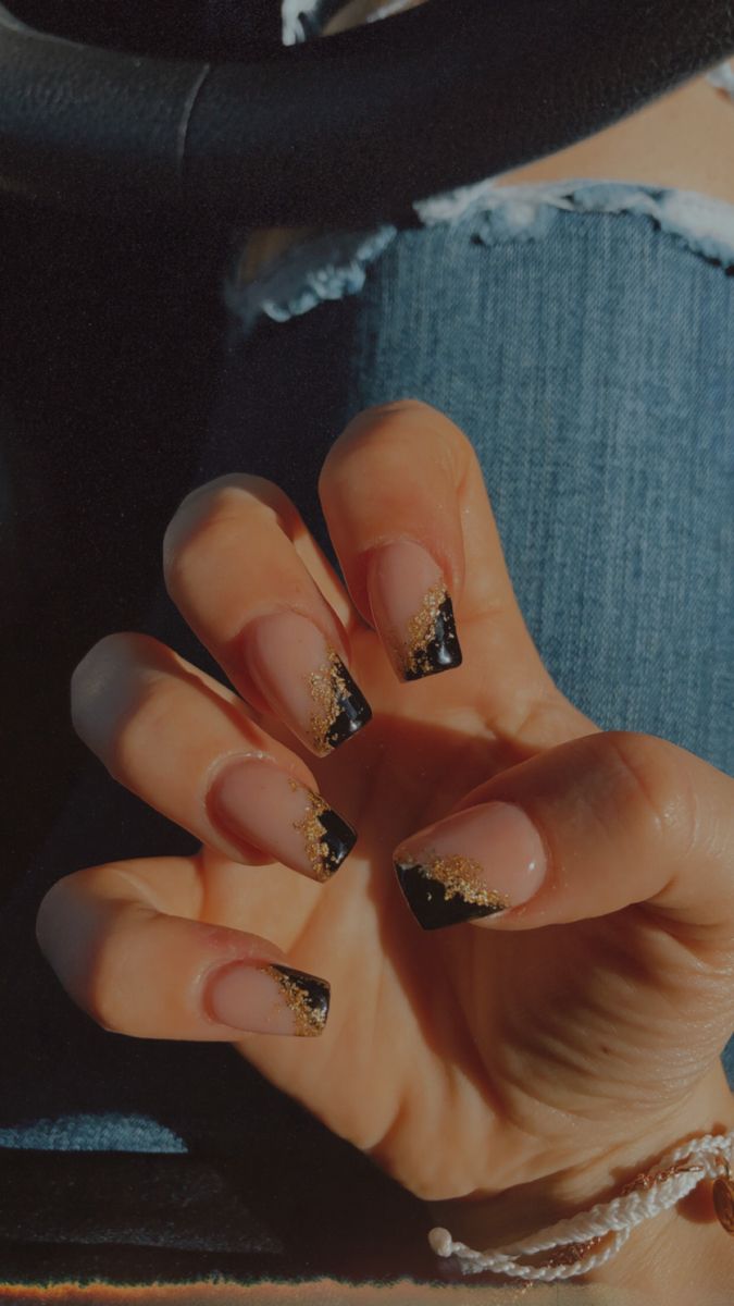 Chic Elegant Nail Design: Glossy Black Tips with Gold Glitter Gradient and Pink Accents.